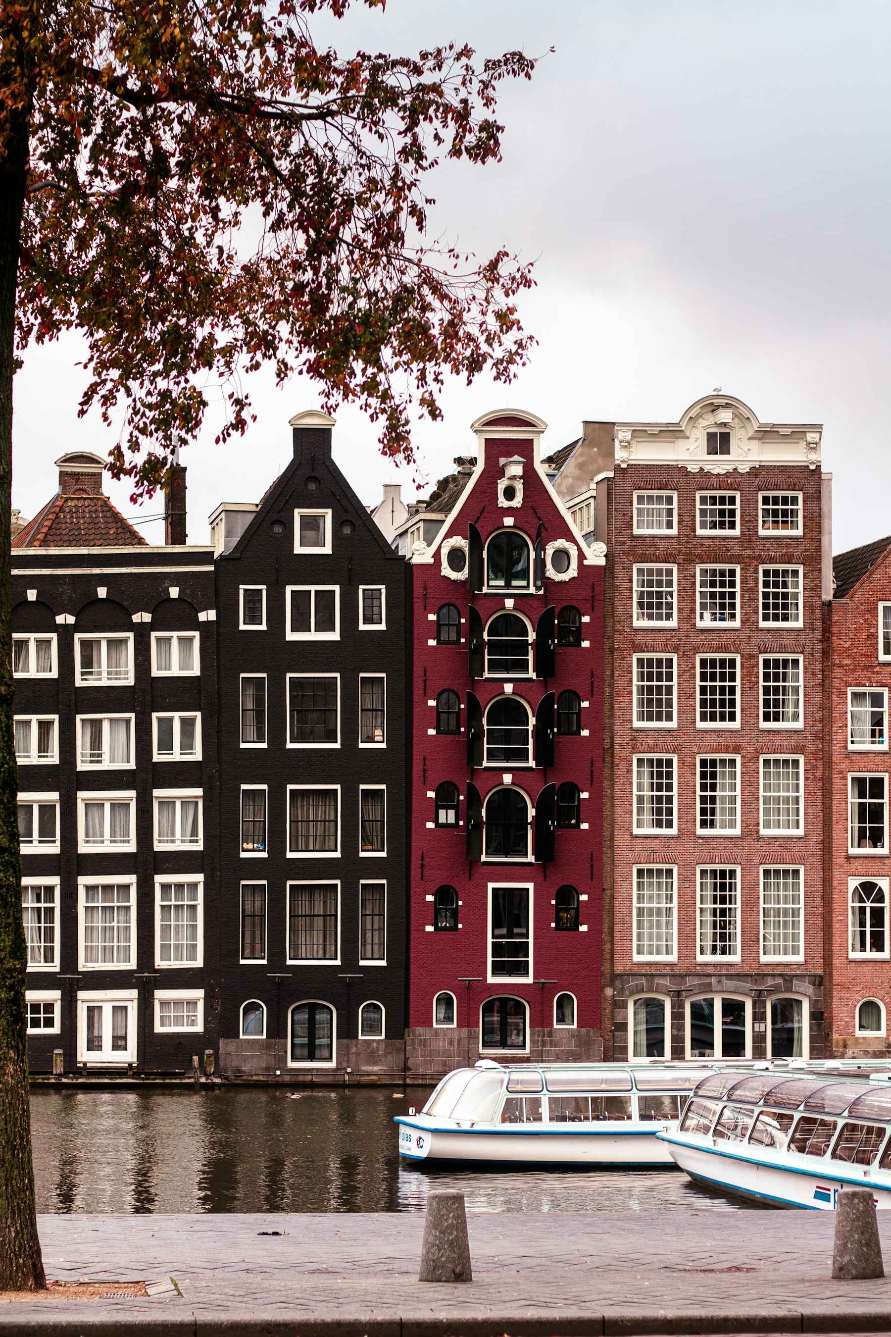 A row of Amsterdam canal houses along the water